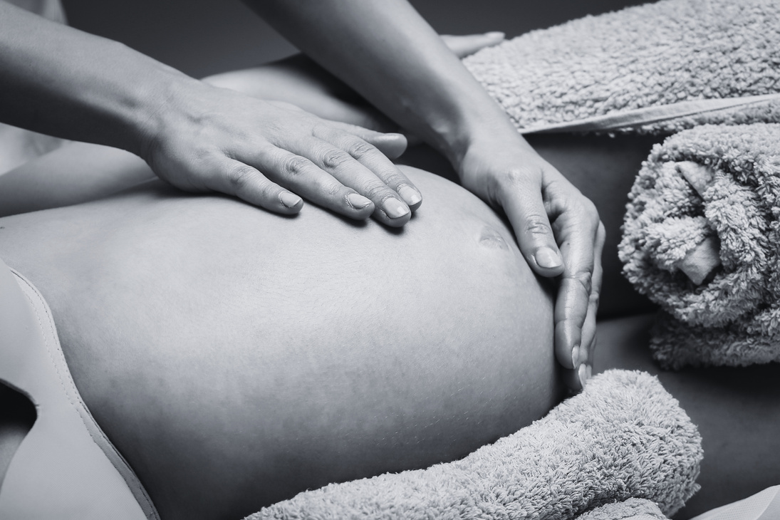 Massage therapist massaging pregnant woman
